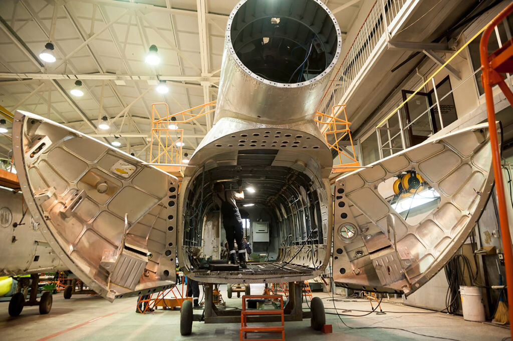 Aircraft repair happening on a Helicopter.