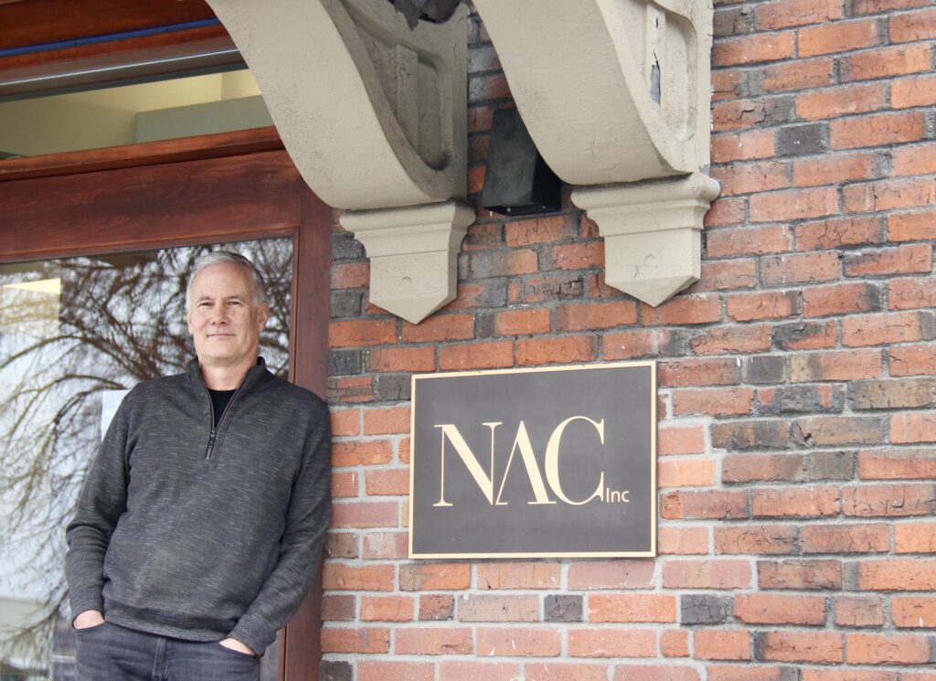 Dana Harbaugh of NAC Architecture is pictured with the NAC logo.