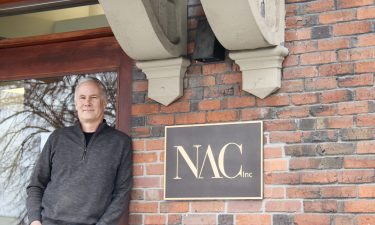 Dana Harbaugh of NAC Architecture is pictured with the NAC logo.