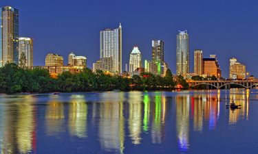 Austin skyline from the shores of Lady Bird Lake at twilight